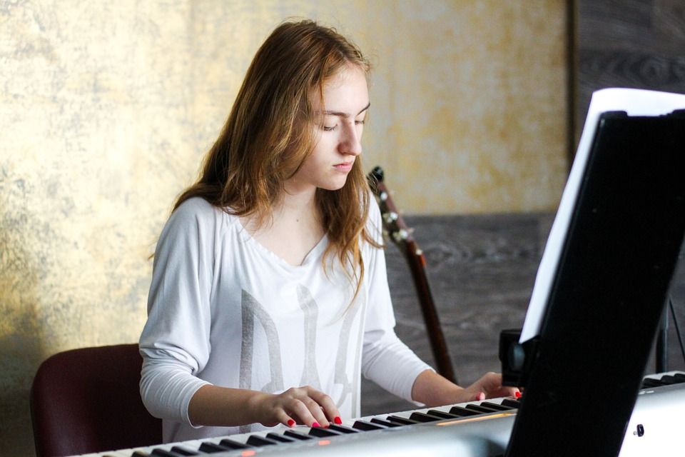 Girl playing Yamaha DGX 660